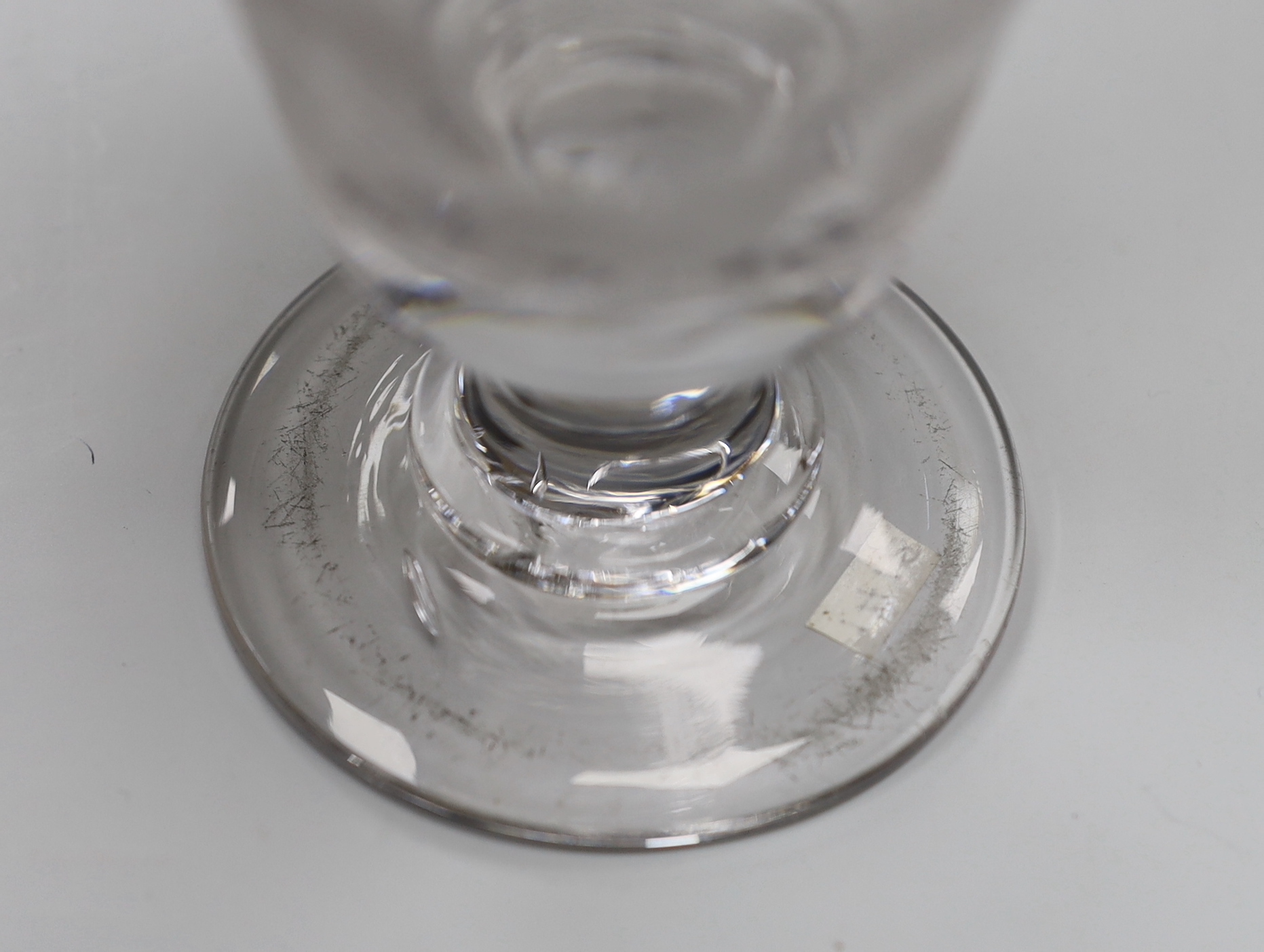 An English lead crystal engraved goblet/rummer, c.1800, bucket bowl, engraved with fruiting vines, a rose and scripted initials, possibly ‘JAB’ or ‘TAB’, capstan stem and plain foot with rough pontil, 13.3cm high